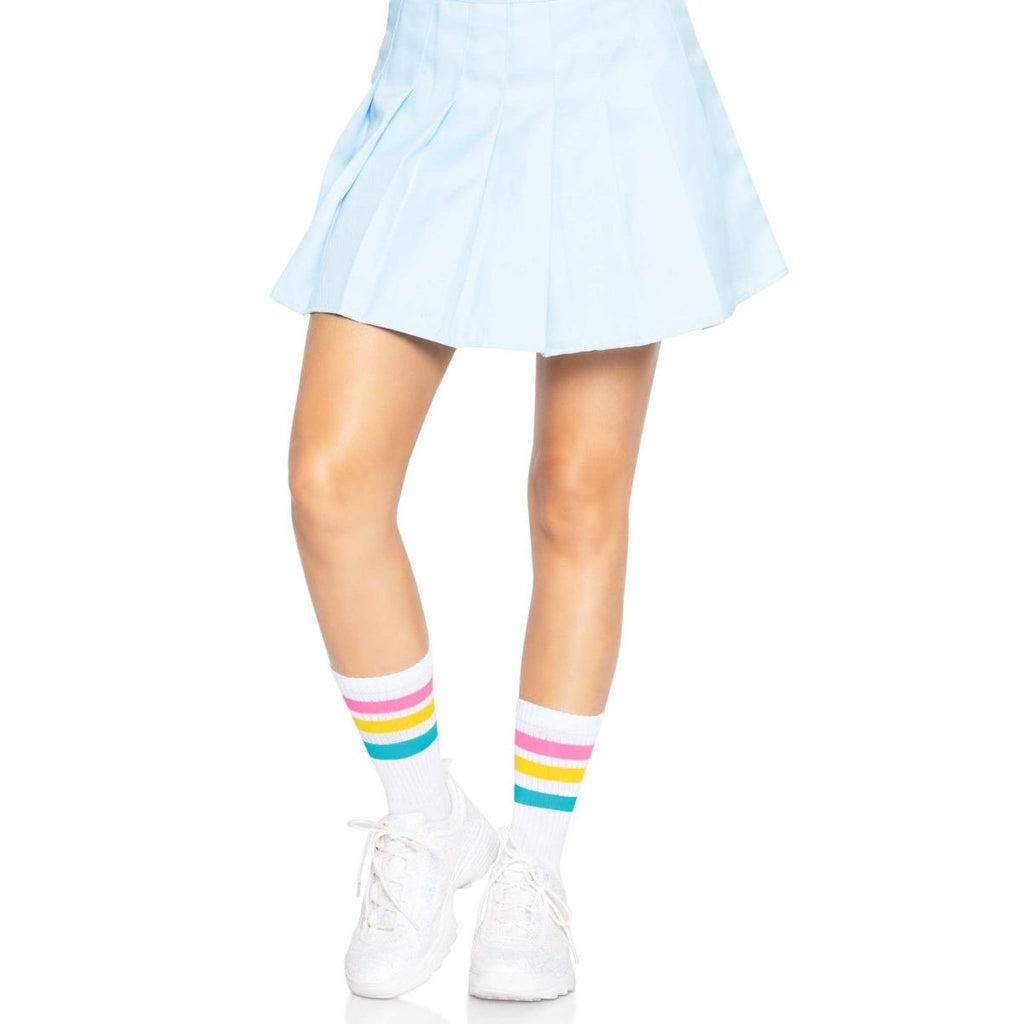 Pride Crew Socks with rainbow stripes worn with a light blue pleated skirt and white sneakers.