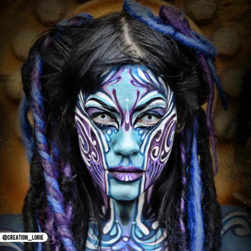 Person with blue-purple zombie makeup wearing PRIMAL Zombie I Colored Contact Lenses.