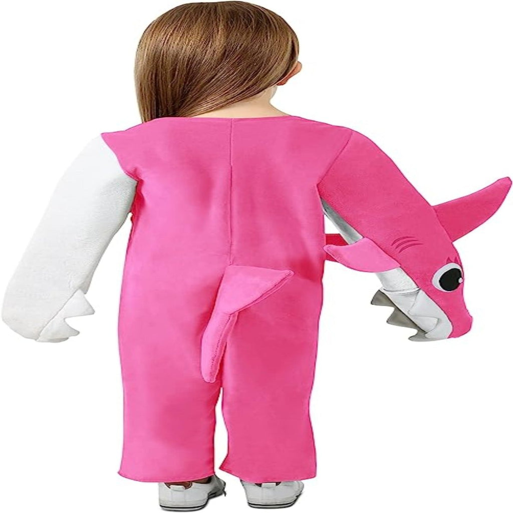 Child wearing pink PinkFong Chompin' Mommy Shark costume, plush onesie with shark head on sleeve and tail, back view.