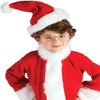Child in Santa suit with white fur trim and round glasses.